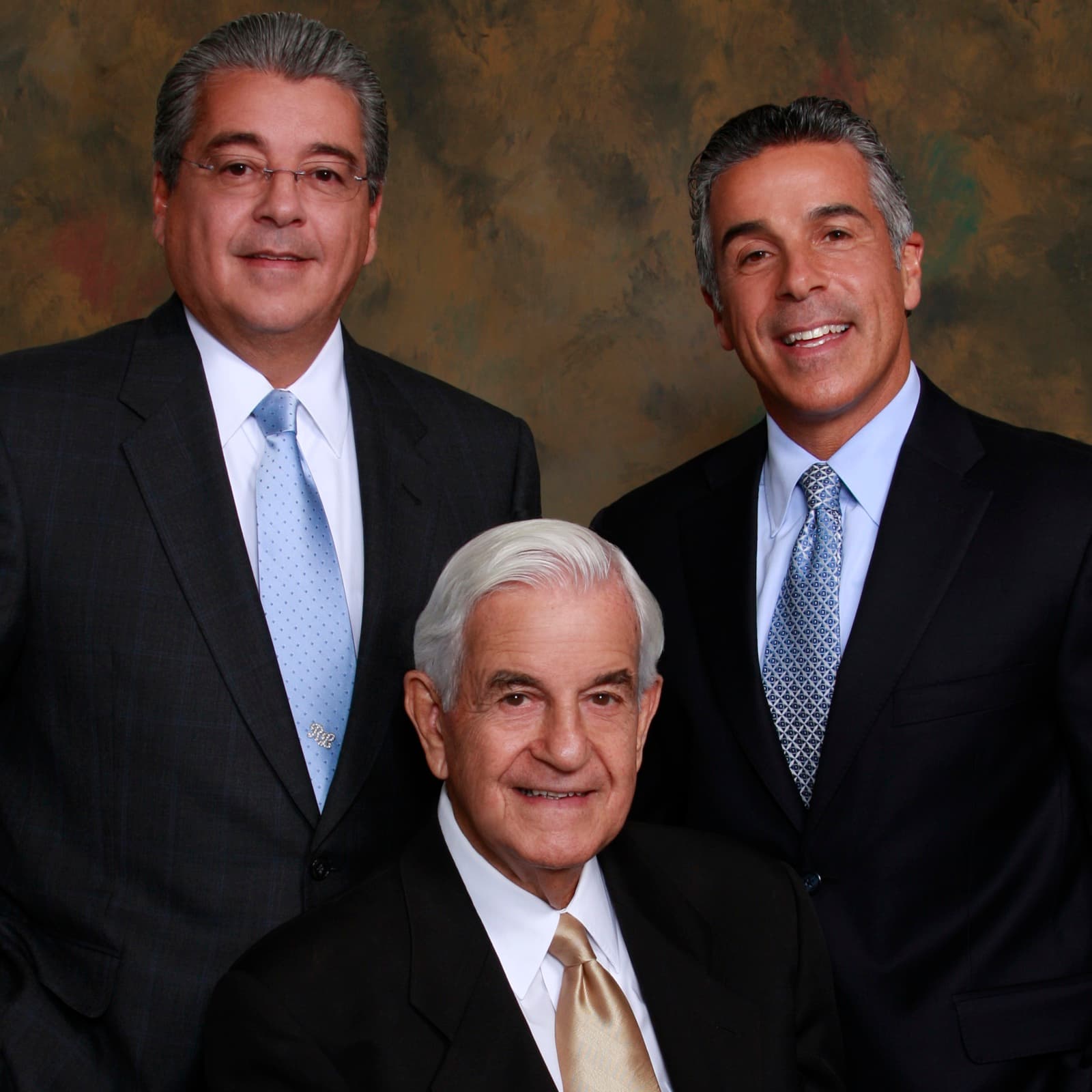Richard LoRicco Sr. (seated, center) with sons Ronald LoRicco Sr. (left) and Richard LoRicco Jr. (right). Studio portrait, c. 2010s.